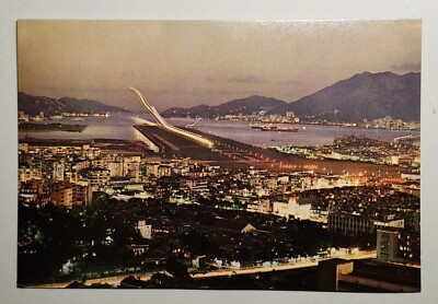 View of plane making a night landing at Kaitak - Hong Kong Postcard