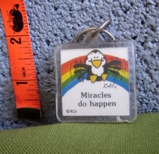 MIRACLES DO HAPPEN plastic keychain 1980s cute penguin flying over rainbow