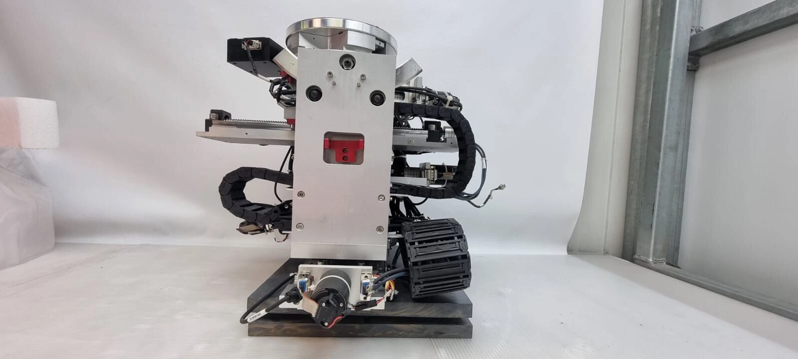 End view of the stage with upright side plate, cable carriers and motor