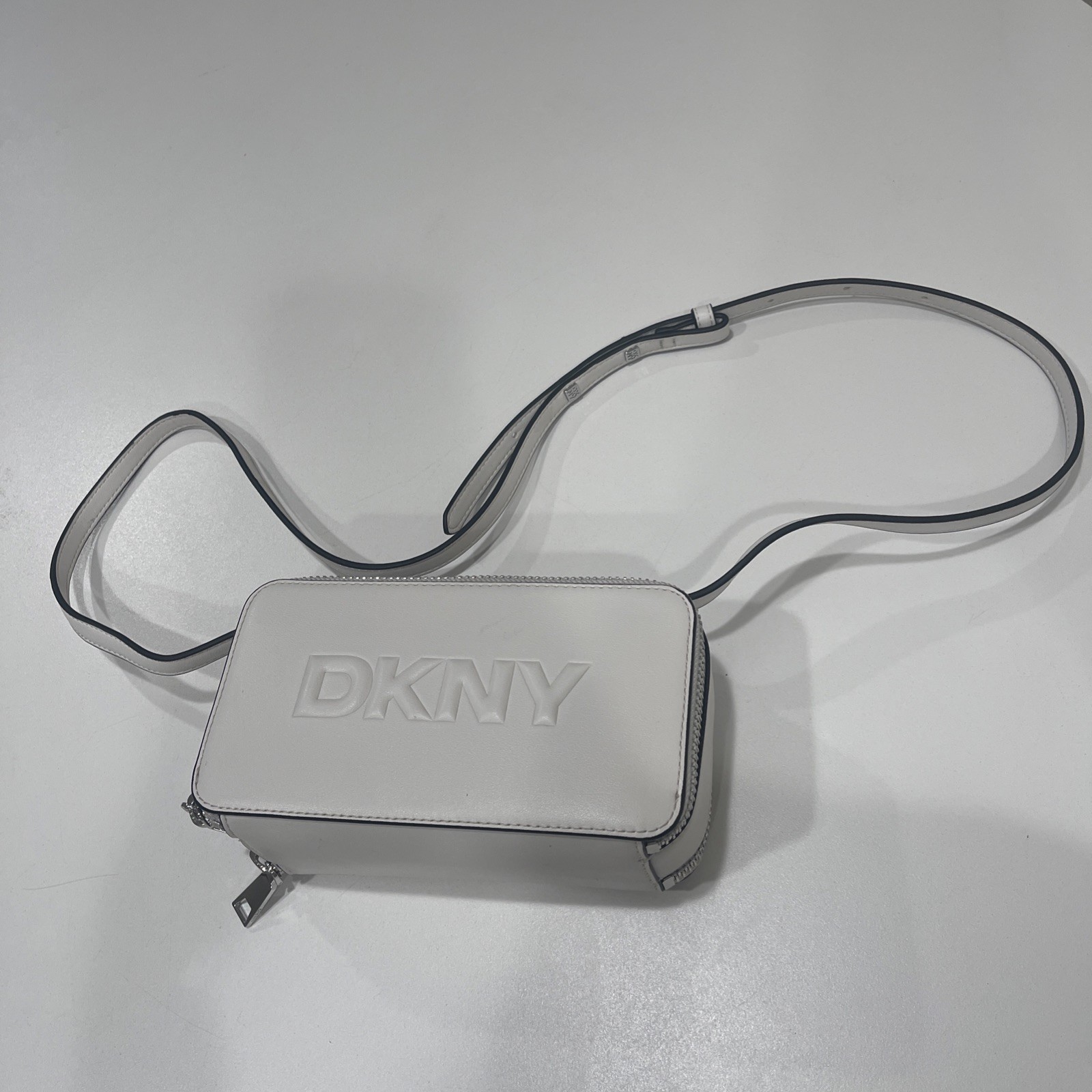 DKNY logo-embossed zip-top bag White