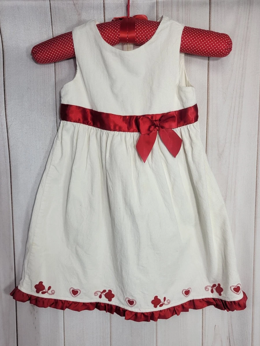 White jumper 2025 with red bow
