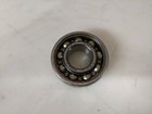 Metal NDH 3202 bearing with visible ball bearings, made in USA, on a white surface.