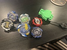 Beyblades Lot Of 4 Plastic And Metal With Accessories