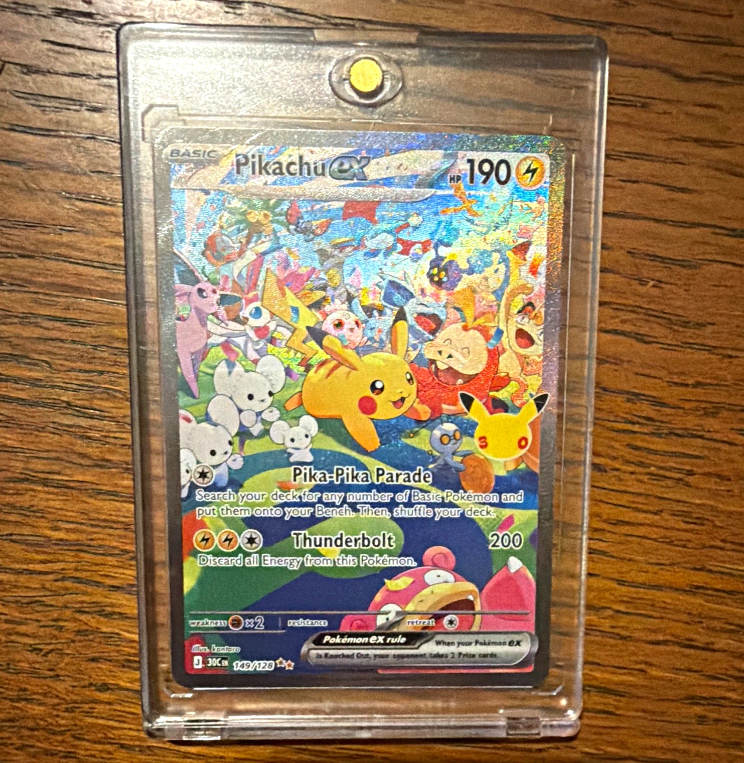 A Pokemon card in a rigid toploader