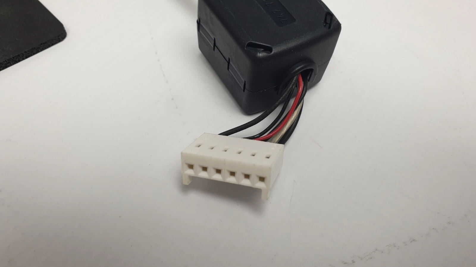 Clip-on ferrite core and connector on the panel cable