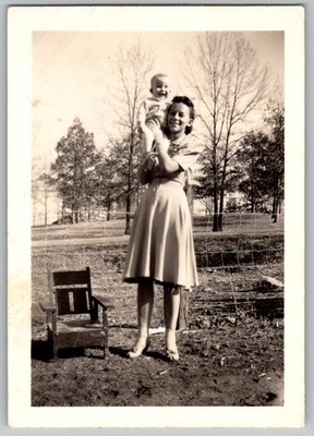 Vtg B&W Snapshot Woman Holding Baby On Shoulder Outdoors Fence & Chair 1940s