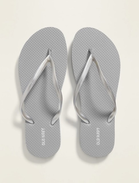 white and silver flip flops