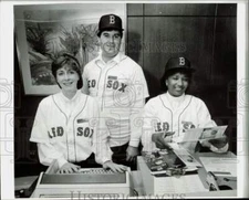 1990 Press Photo Sheraton check-in counter personnel wearing Red Sox uniforms