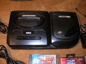 sega cd model 2 console and genesis/ w games