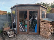 Corner garden shed / summer house with built in storage and seating
