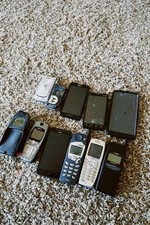 Old vintage phone lot. Mixed brands such as Motorola, HTC, Nokia, Sprint, etc.