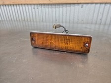 1983-1986 Datsun Nissan 720 OEM passenger side bumper marker light small cracks