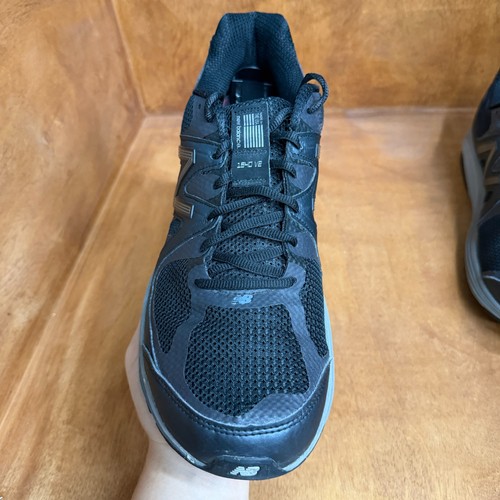 Black and gray New Balance 1540V2 men’s running shoes with mesh upper, suede panels, and “Made in USA” label on side.