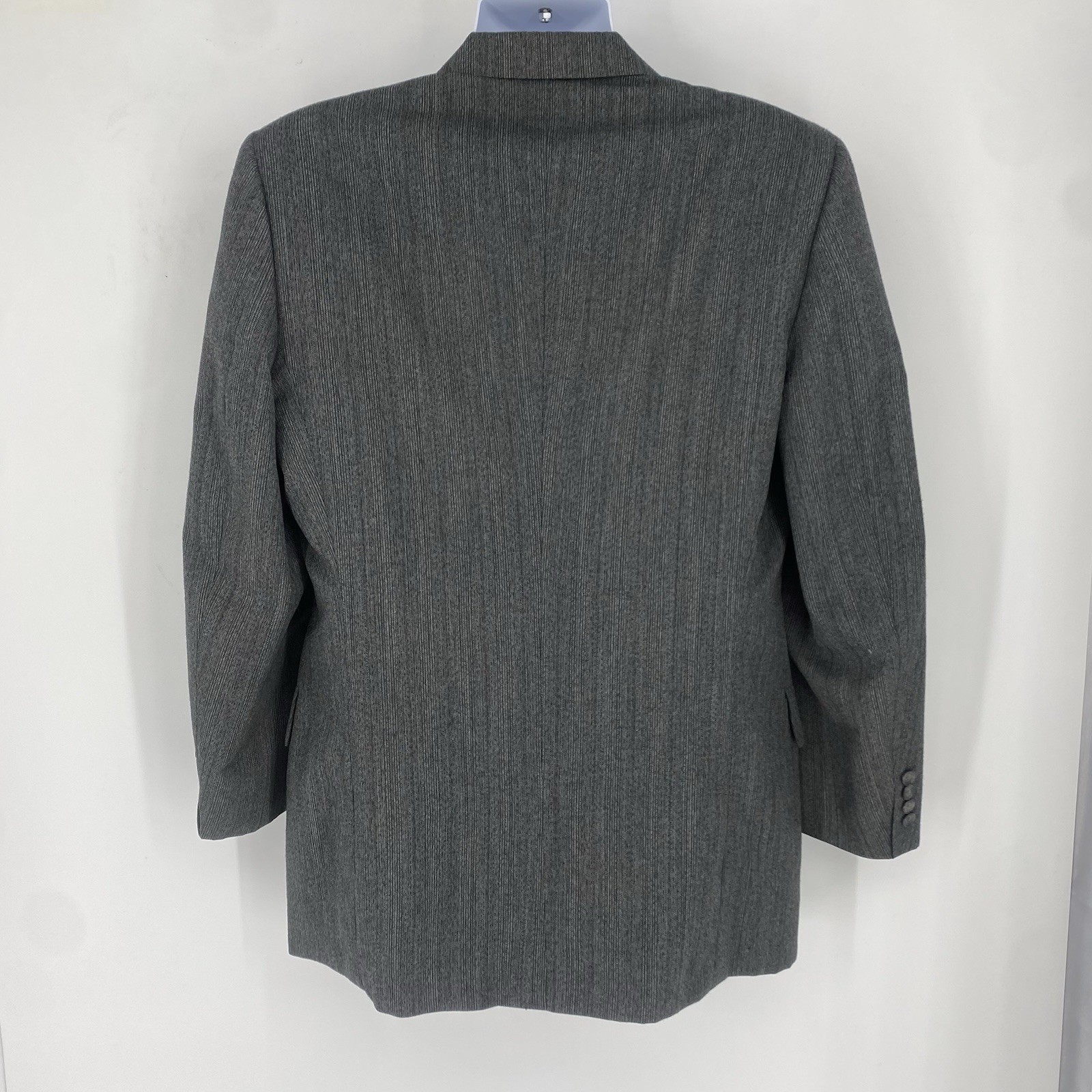 Grey vintage Christian Dior Monsieur suit jacket with subtle vertical pinstripes, notch lapel, and back zipper closure.