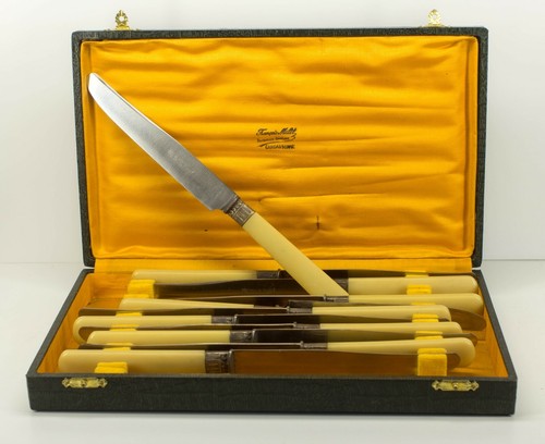 A set of 12 table knives and 12 cheese knives with lacquered handles