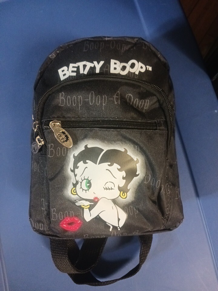 betty boop mini backpack Karriage-Mate (#AH, 913) Features Betty Boop printed on the pink backpack Betty Boop Mini Backpack. Betty