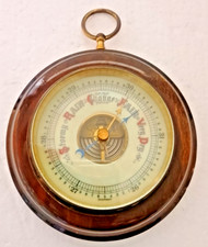 German made small circular Aneroid Barometer on a wooden base measures 10cm diam