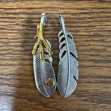 Two Silver Colored Feather Charms