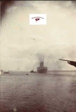 RMS TITANIC LEAVING SOUTHAMPTON, BOW OF NEW YORK IN FOREGROUND