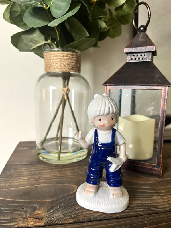 Hand Painted Ceramic Boy Figurine Blue Overalls White Hair Holding Toy