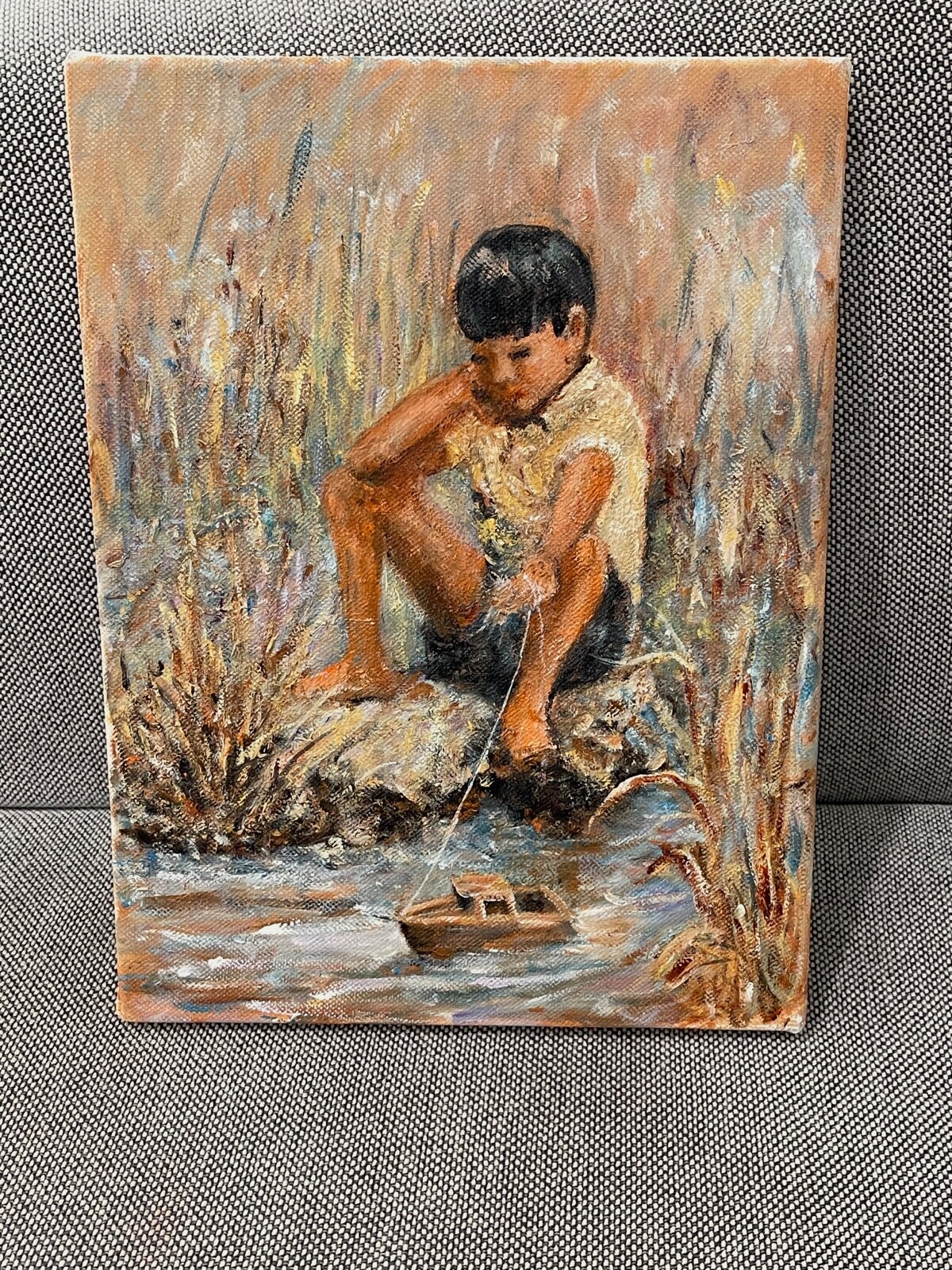 On Canvas Painting Of A Young Boy With Toy Boat By Water