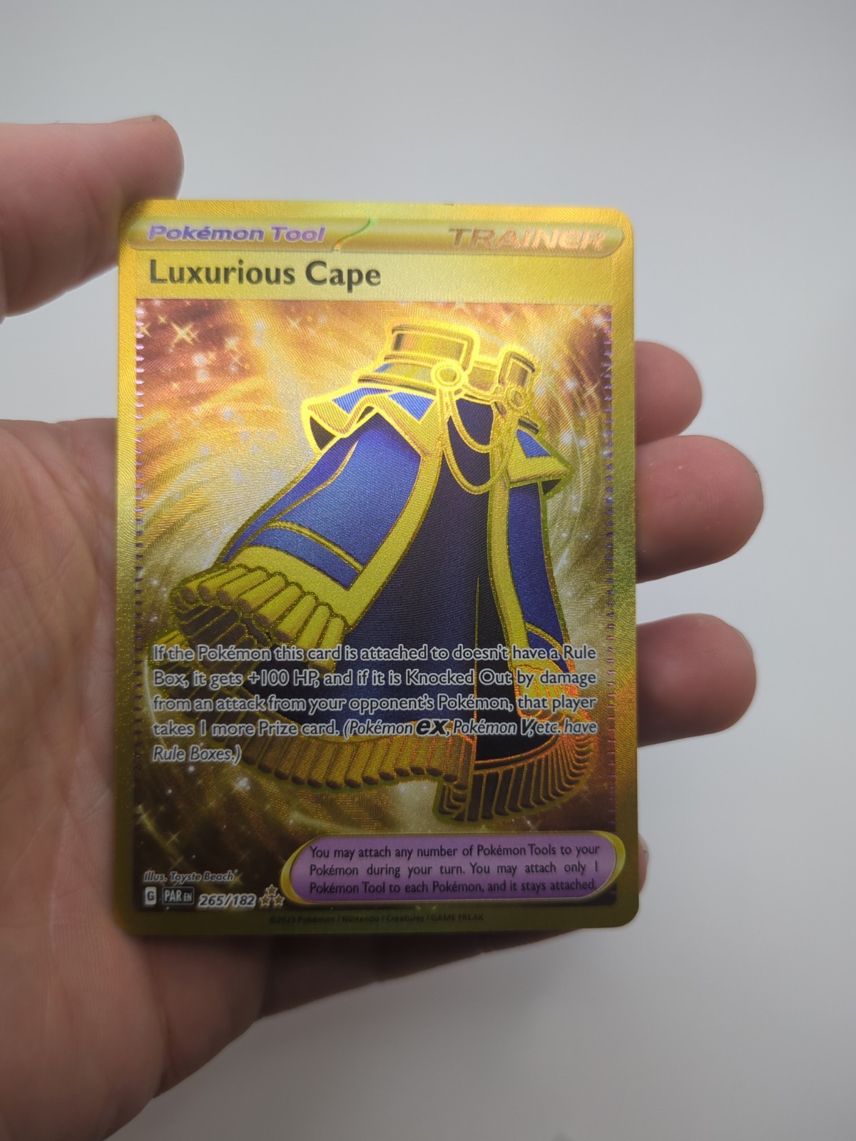 Luxurious Cape 265/182 Paradox Rift Gold Secret Rare Pokemon TCG NM/MINT