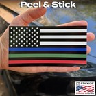 Hand holding a thin blue American flag sticker with white stars and green and red horizontal stripes, black border, Made in USA.