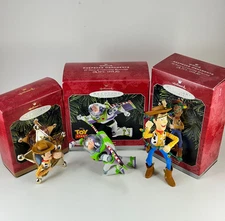 3 Toy Story Hallmark Ornaments - Woody's Roundup, Buzz Lightyear, Woody Sherif