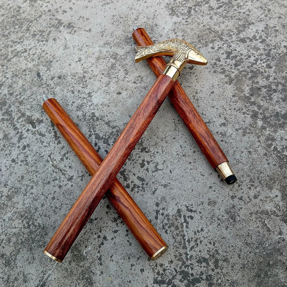 A handmade brass fish-handle walking cane that straddles the line between functional gentleman's accessory and display-worthy art object.
