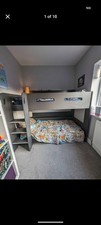Black bunk beds with shelves for both beds.