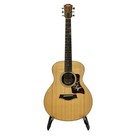 Light wood Taylor GS mini electric acoustic guitar with gold hardware, six strings, and ornate floral pickguard.