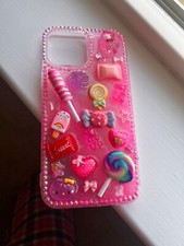 Junk phone case, pink glitter case with pretty charms included on it.
