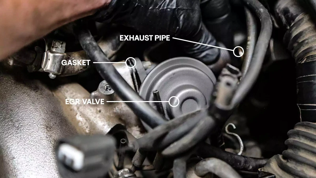 Installing the new EGR valve on the exhaust manifold.