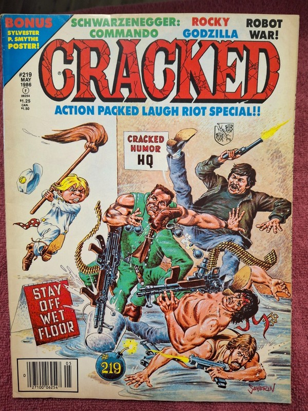 1986 Cracked Magazine #219 (May) - Schwarzenegger / Stallone (w/ intact poster)