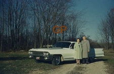 XX113-Old 35mm Slide Photo- Man and Woman by a Car- 1962