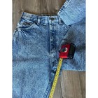 Light blue high-rise vintage Lee jeans size 8 with faded front thighs, five-pocket design, and yellow measuring tape.