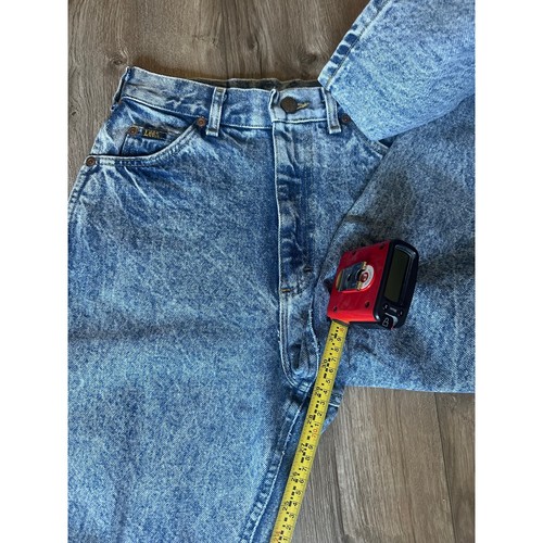Light blue high-rise vintage Lee jeans size 8 with faded front thighs, five-pocket design, and yellow measuring tape.