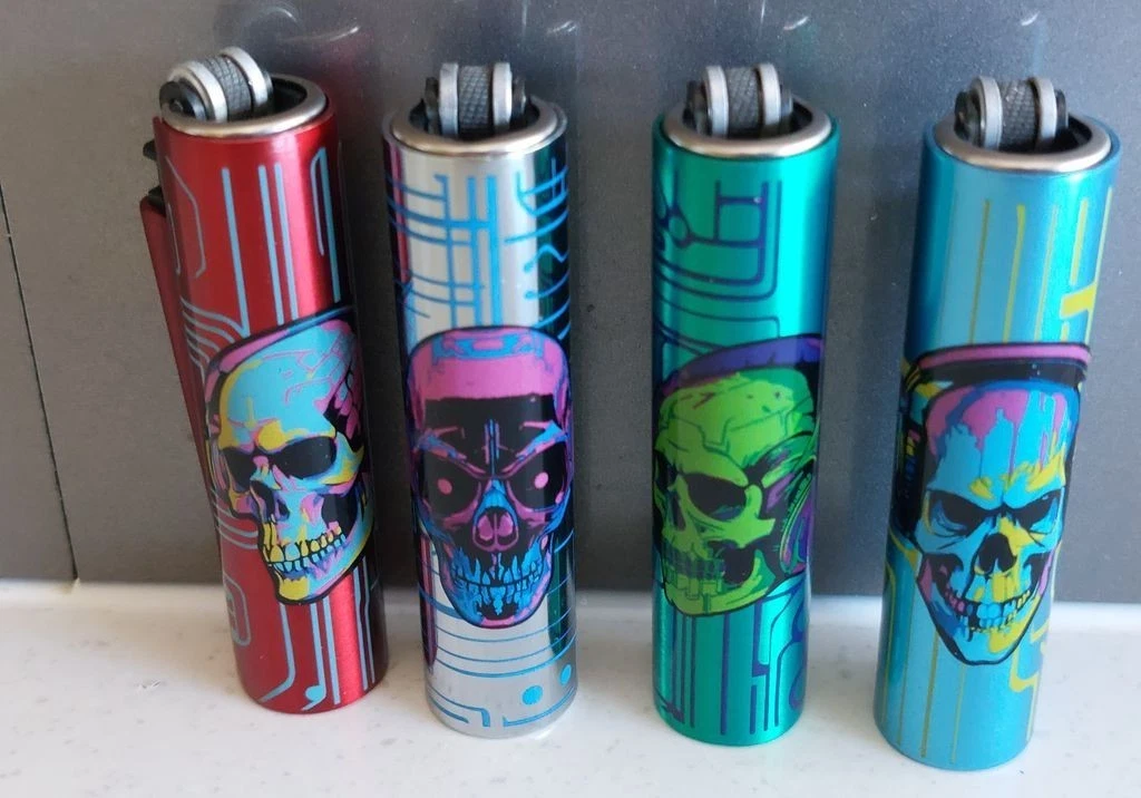 Clipper  4 x Micro  Refillable Lighters  collectable in metal skull cases - Picture 1 of 4