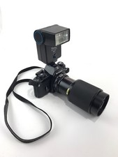 Nikon EM 35 mm film camera with Vivitar 75-205mm lens and original strap  Flash