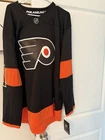 Travis Konecny underwraps vol2 Flyers Autographed Hockey Jersey Black Orange.