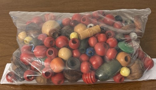 Huge lot of wood beads all different sizes. Great for crafts.