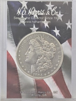1884-O $1 Morgan Silver Dollar in Unc. In H.E.Harris Capsule 