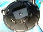 Black GM 231 distributor cap with visible metal parts, wiring, and a rectangular black control panel on a blue background.