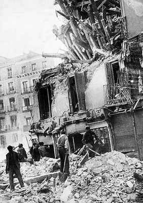 Workmen in Madrid try to clear away some of the rubble created whe- Old Photo