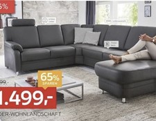 Große schwarze Leder-Eckcouch mit Hocker von XXL Lutz