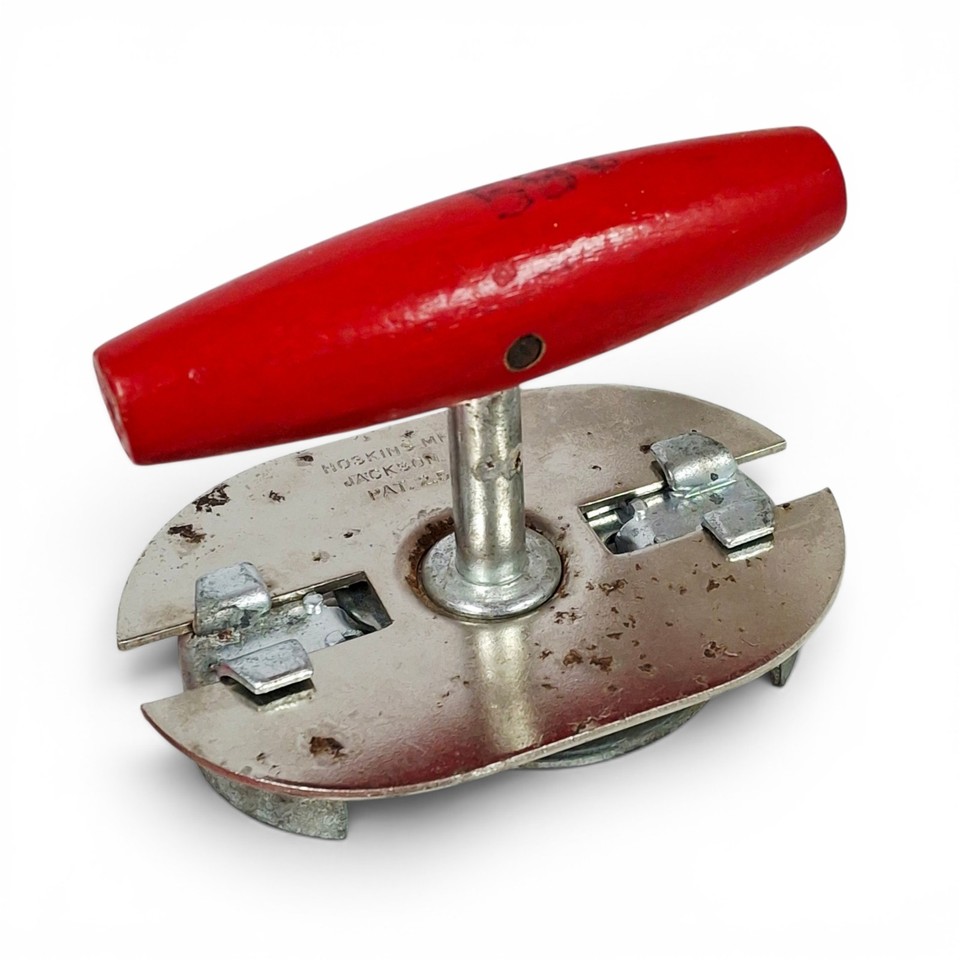 A chunky wood-handled, red-lacquered American-made jar opener that looks as good on a pegboard as it works in the kitchen.