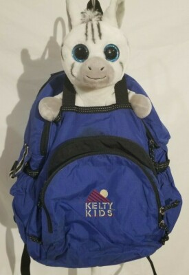 blue Kelty kids backpack, stuffy and pencil holder