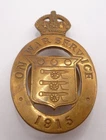 WW1 ON WAR SERVICE 1915 LAPEL BADGE - WOOLEY & CO NO 6599