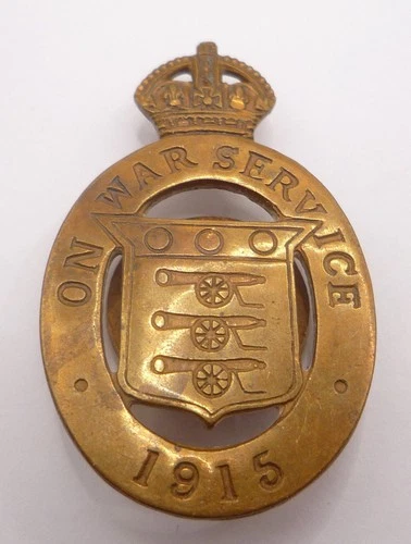 WW1 ON WAR SERVICE 1915 LAPEL BADGE - WOOLEY & CO NO 6599
