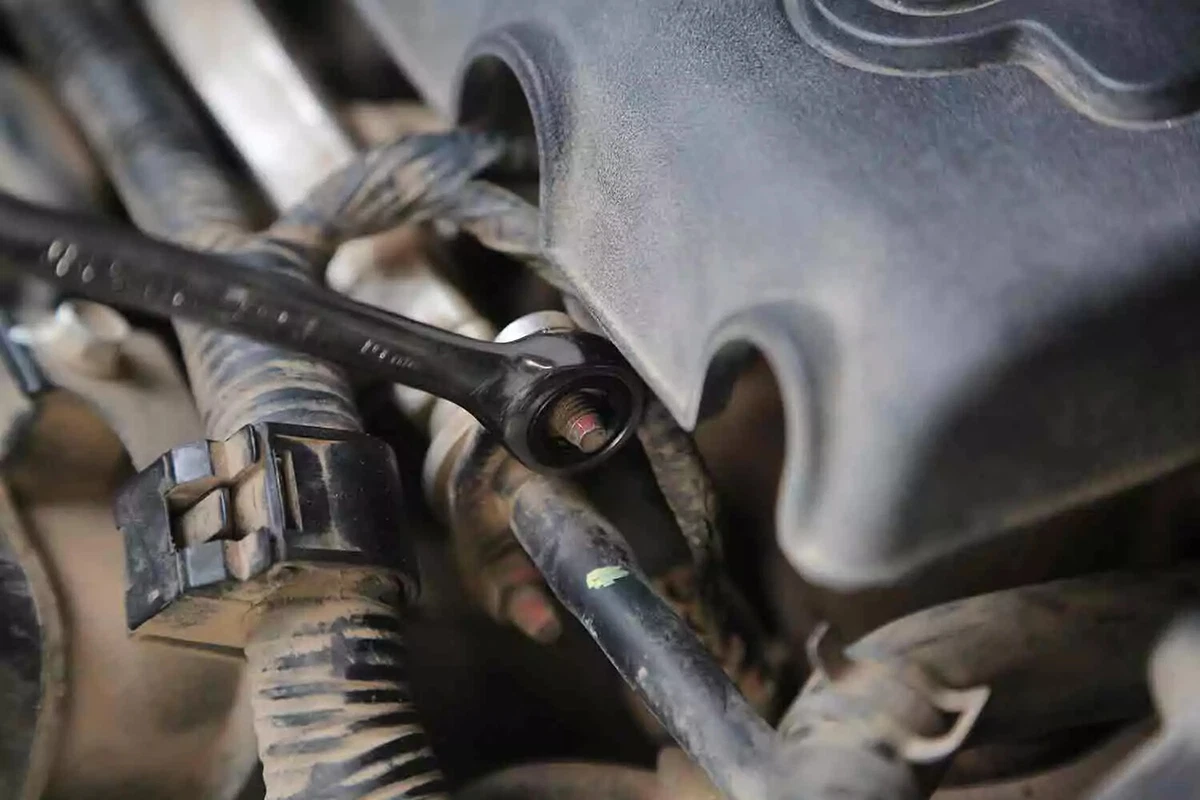 A line wrench is used to loosen the fuel line.
